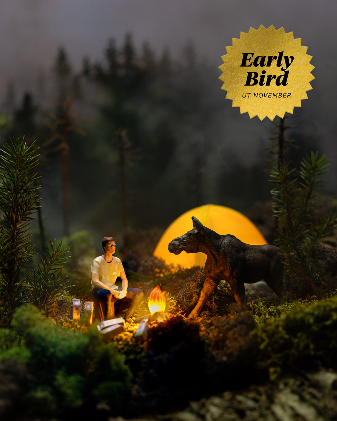 En modell som viser en mann, bål, melkepakker, en telt og en elg. 